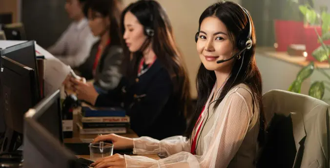 A customer service agent on a call at their desk