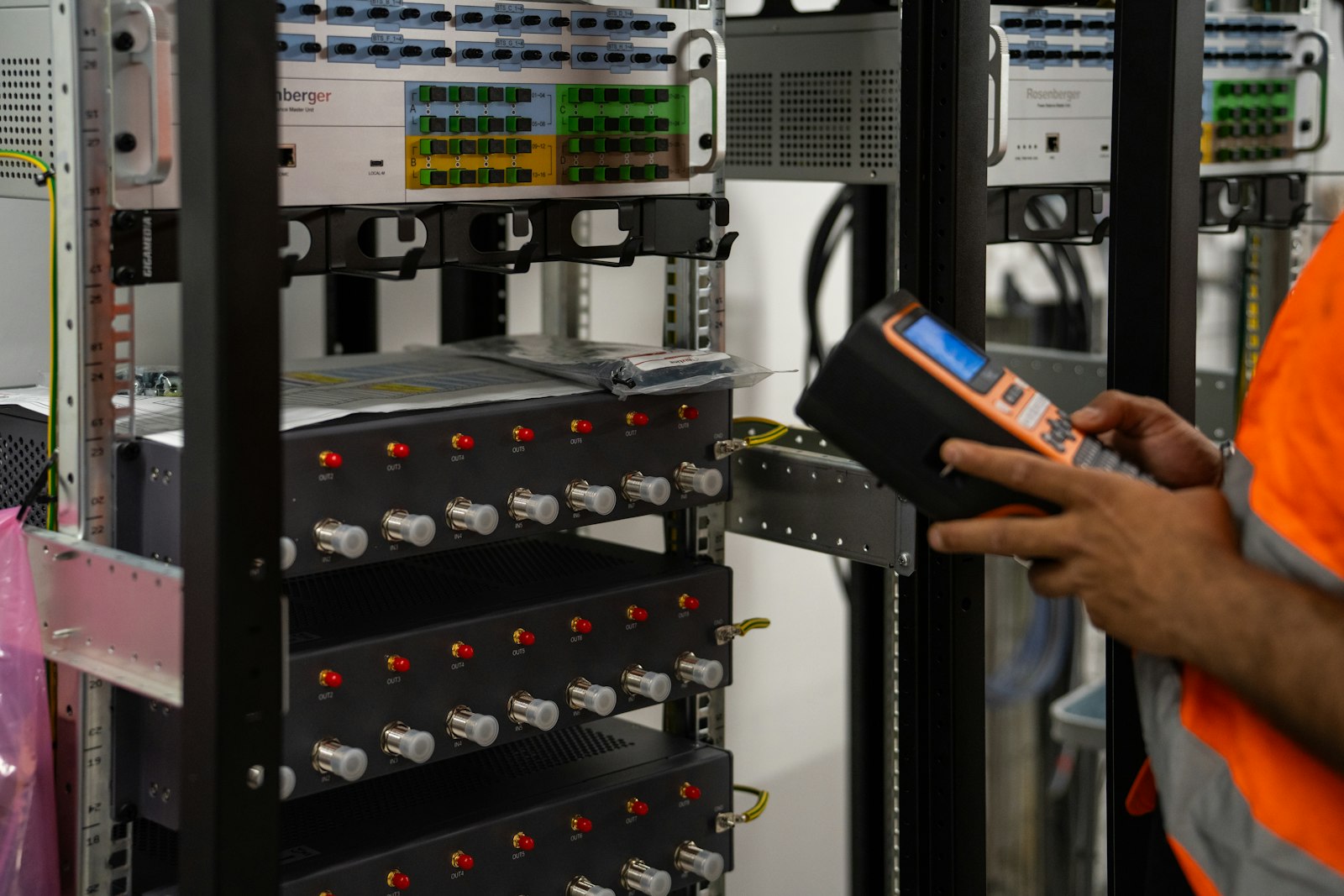 A technician inspecting equipment in a server room